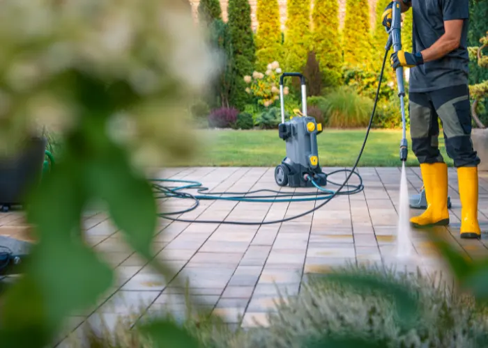 A polished concrete worker cleaning & sealing a decorative concrete patio
